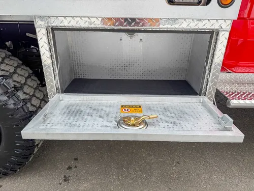 Lower side compartment open with drop-down platform and floor mat.